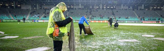 Here's something you don't see every day: Soaked football pitch in Slovenia "dried" with towels